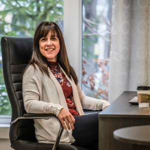 Woman sitting at desk, smiling